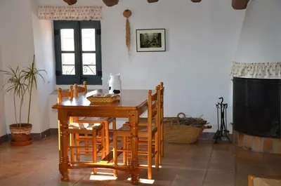 a wooden table and chairs in a living room at RCP El Racó in Pacs del Penedes