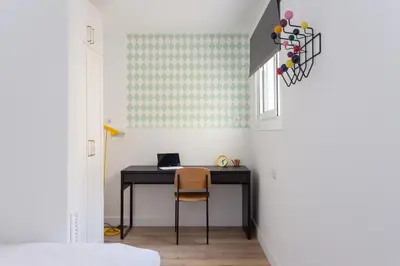 a desk in a hallway with a room with white walls at Casa Cosi - Atico in Barcelona