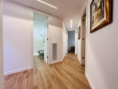 a hallway with a door leading to a room with a window at Sono Master Apartments in La Garriga