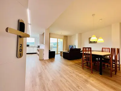a dining room and living room with a table and chairs at Sono Master Apartments in La Garriga