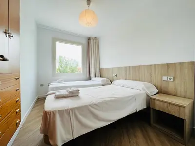 a bedroom with two beds and a window at Sono Master Apartments in La Garriga