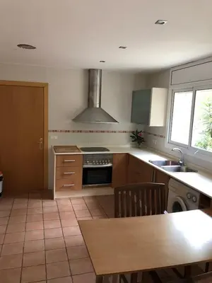 a kitchen with a sink and a stove top oven at Casa Bella Vista en montaña con vistas al mar y piscina privada in Cunit