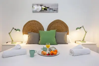 a bed with a plate of fruit on it at Stay U-nique Apartments Provença in Barcelona