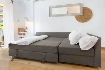 a bed with two pillows on it in a room at Stay U-nique Apartments Provença in Barcelona
