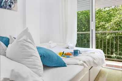 a white room with a bed with a breakfast on it at Stay U-nique Apartments Provença in Barcelona