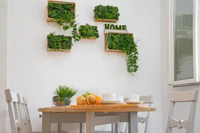 a dining room table with plants on the wall at Stay U-nique Apartments Sicília in Barcelona