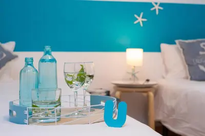 a tray with glasses and bottles on a bed at Stay U-nique Apartments Sicília in Barcelona