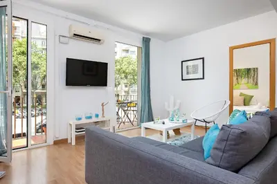 a living room with a couch and a tv at Stay U-nique Apartments Sicília in Barcelona