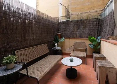 a patio with two benches and a table at Stay U-nique Apartments Floridablanca in Barcelona