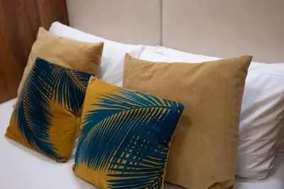 a group of pillows sitting on top of a bed at Stay U-nique Apartments Floridablanca in Barcelona