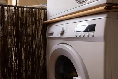 a white washing machine sitting next to a fence at Stay U-nique Apartments Floridablanca in Barcelona
