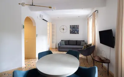 a living room with a white table and chairs at Stay U-nique Apartments Floridablanca in Barcelona