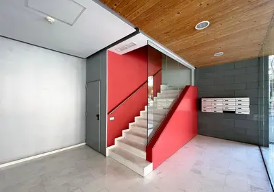 a staircase in a room with a red wall at Stay U-nique Apartments Degà Bahí in Barcelona
