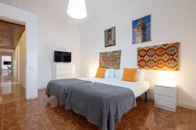 a bedroom with a white bed and a tv at Stay U-nique Apartments Casanova in Barcelona