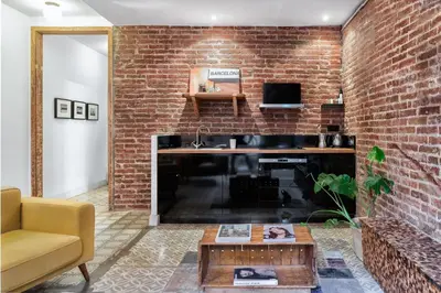 a living room with a brick wall and a fireplace at Brummell Apartments Eixample Izquierda/Valeris in Barcelona