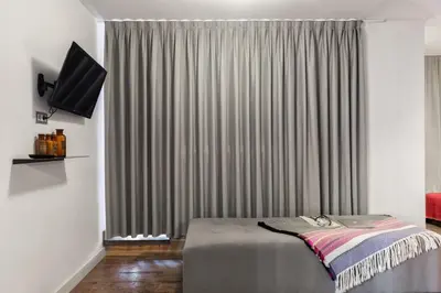 a bedroom with a bed and a window with curtains at Brummell Apartments Eixample Izquierda/Valeris in Barcelona