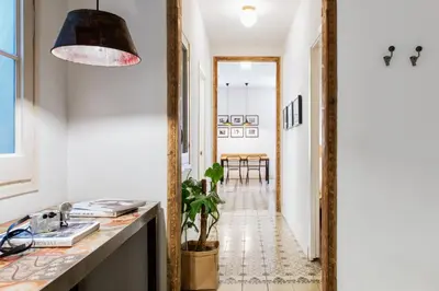 a hallway with a mirror and a table at Brummell Apartments Eixample Izquierda/Valeris in Barcelona