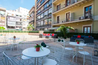 a patio with tables and chairs in front of a building at BacHome Terrace B&B in Barcelona