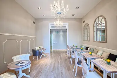 a dining room with tables and chairs and a chandelier at BacHome Terrace B&B in Barcelona