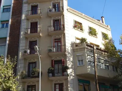 a tall white building with balconies and plants on it at Apartment Eixample Dret Valencia - Cartagena by Interhome in Barcelona