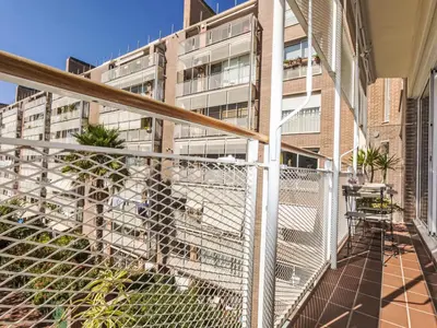a person standing on a balcony in front of a building at Apartment Vila Olimpica Sant Marti by Interhome in Barcelona