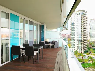 a balcony with tables and chairs on a building at Apartment Diagonal Mar by Interhome in Barcelona