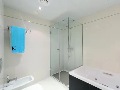 a glass shower in a bathroom with a sink and a tub at Apartment Diagonal Mar by Interhome in Barcelona