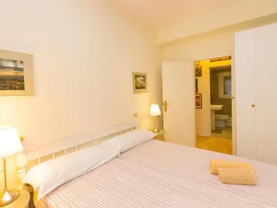 a bedroom with a large bed and a bathroom at Apartment Eixample Dret Corsega Roger Lluria by Interhome in Barcelona
