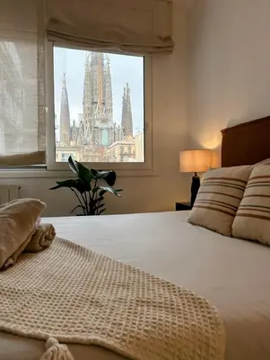 a bedroom with a bed and a window with a view at Apartment Eixample Dret Aragon - Sardenya in Barcelona