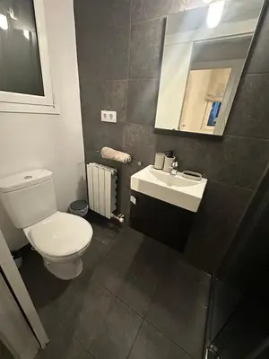 a bathroom with a white toilet and a sink at Apartment Eixample Dret Aragon - Sardenya in Barcelona
