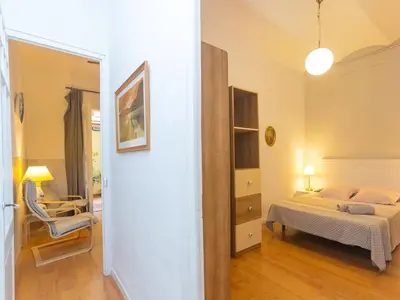 a bedroom with a bed and a chair in a room at Apartment Gracia Torrijos by Interhome in Barcelona