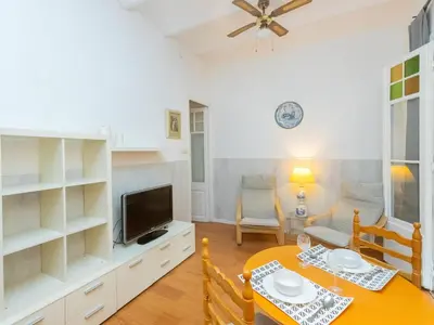 a dining room with a table and a tv at Apartment Gracia Torrijos by Interhome in Barcelona