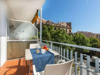 a balcony with a table and chairs on a building at Apartment Eixample Esq Rocafort Diputacio by Interhome in Barcelona