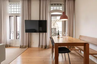 a kitchen with green cabinets and a dining room at Gòtic by The 5ve Soul in Barcelona