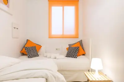 a bedroom with two beds and a window at Stay U-nique Apartments Ricart in Barcelona