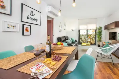 a dining room and living room with a table and chairs at Stay U-nique Apartments Ricart in Barcelona
