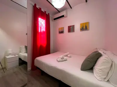 a bedroom with a bed with a red curtain at Stay U-nique Apartments Fontrodona in Barcelona