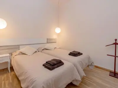 two beds in a room with towels on them at Apartment Eixample Esquerre Arago Rocafort by Interhome in Barcelona
