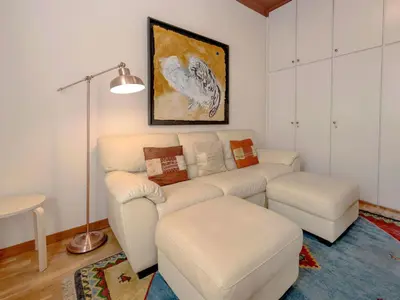 a living room with a couch and a table at Apartment Eixample Esquerre Arago Rocafort by Interhome in Barcelona