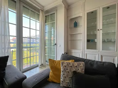 a living room with a couch and a large window at Stay U-nique Apartments Sardenya II in Barcelona