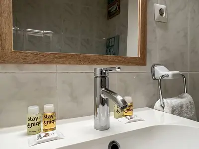 a bathroom sink with a faucet and a mirror at Stay U-nique Apartments Sardenya II in Barcelona