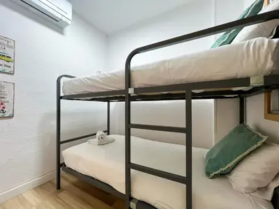 a bunk bed room with two bunk beds at Stay U-nique Apartments Sardenya II in Barcelona