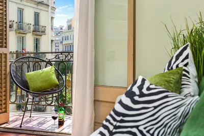a balcony with a chair and pillows on a balcony at Stay U-nique Apartments Provença II in Barcelona