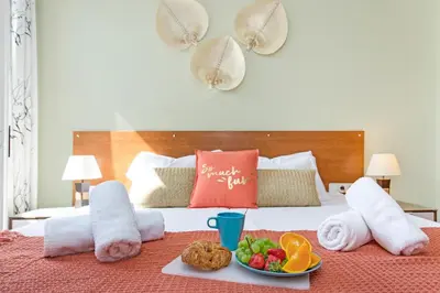a tray of fruit on a bed with towels at Stay U-nique Apartments Provença II in Barcelona