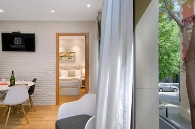 a room with a table and chairs and a window at Eixample Building Apartments by Mercedes Heritage in Barcelona