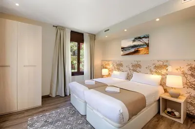 a bedroom with two beds and a window at Eixample Building Apartments by Mercedes Heritage in Barcelona