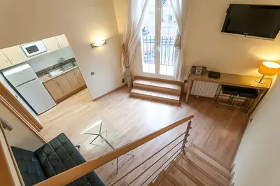 an overhead view of a living room with a television at Alos Apartments Paseo de Gracia-Diagonal in Barcelona