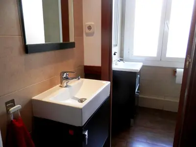 a bathroom with a white sink and a mirror at Barcelona Central Garden Hostal in Barcelona