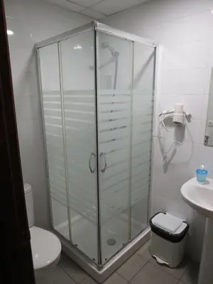 a shower in a bathroom with a toilet and a sink at Hostal Petit Príncep in Barcelona