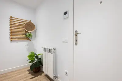 a white room with a radiator and a window at Stay U-nique Apartments Fabra i Puig in Barcelona